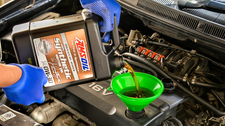 Amsoil motor oil being poured in an engine