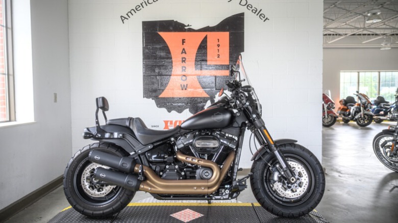 A Harley Davidson bike parked in front of the Farrow dealership logo and text 'America's Oldest Harley Dealer'