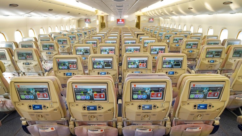 Rows and rows of in-flight entertainment screens are seen on an Emirates plane.