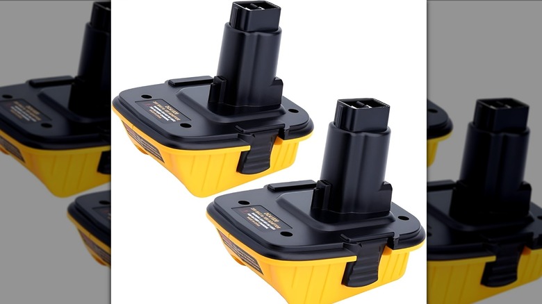 A pair of yellow power tool battery adapters on white background