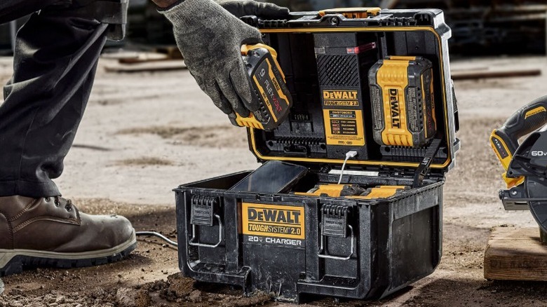 Person using the DeWalt ToughSystem 2.0 20V Dual Port Charger on a jobsite