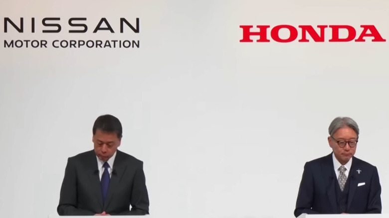 Two executives, one each from Honda and Nissan, at a press conference announcing a (now failed) merger.