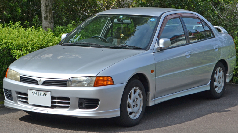 Front 3/4 view of 1995-98 Mitsubishi Lancer MX parked in wooded setting