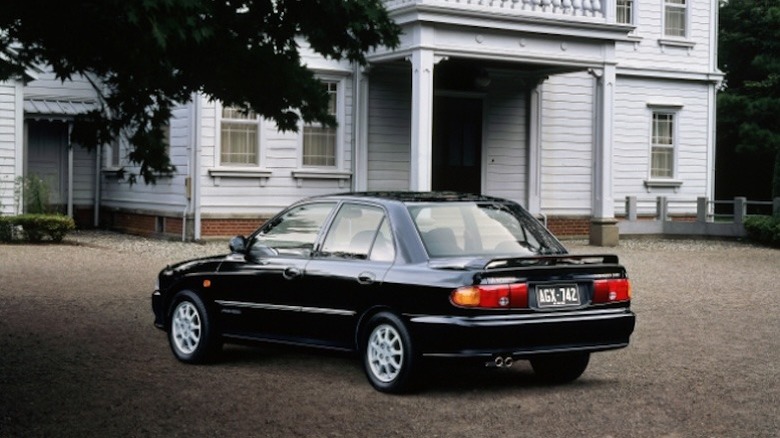 Rear 3/4 view of 1991-1994 Lancer in rural residential setting