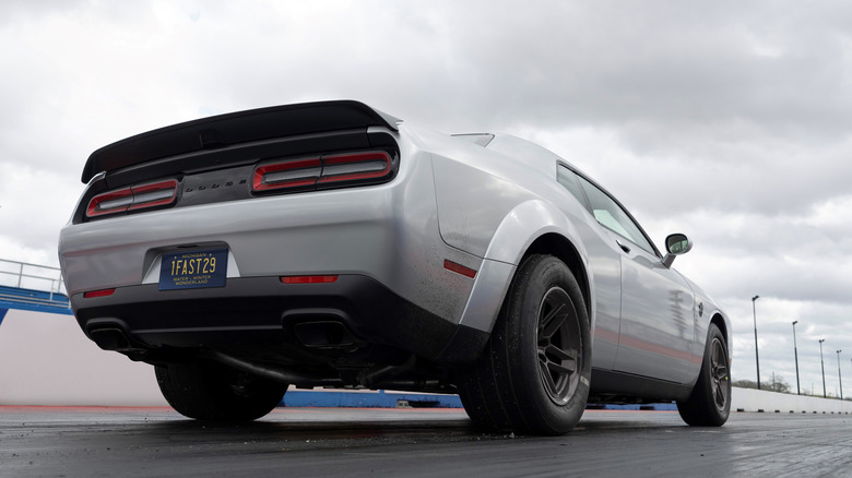 The Dodge Challenger Demon with 315mm rear tires, rear-right view from ground, staging on drag strip