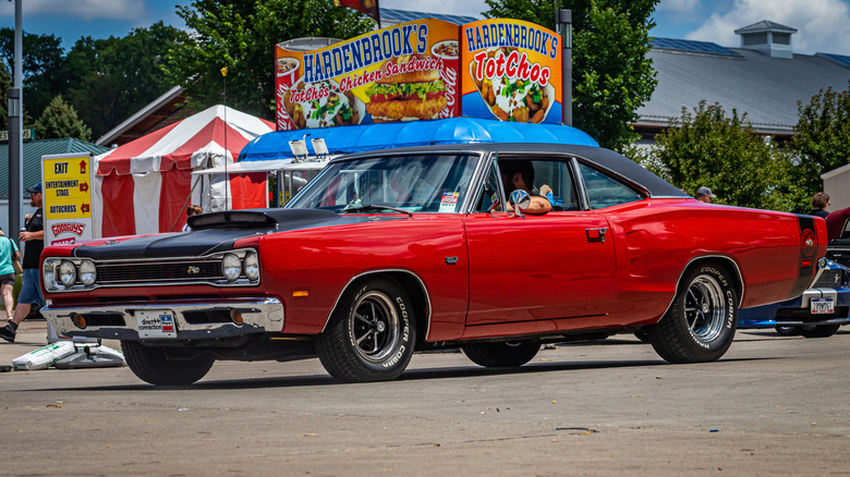 Front 3/4 view of 1969 Dodge Super Bee in car show setting