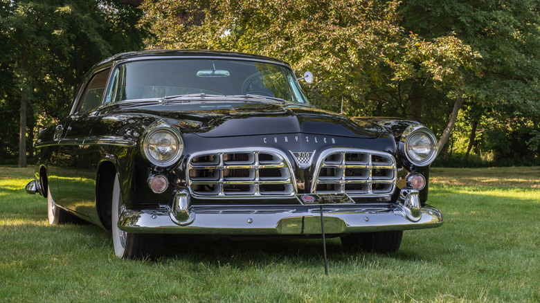 Black Chrysler 300C parked on grass