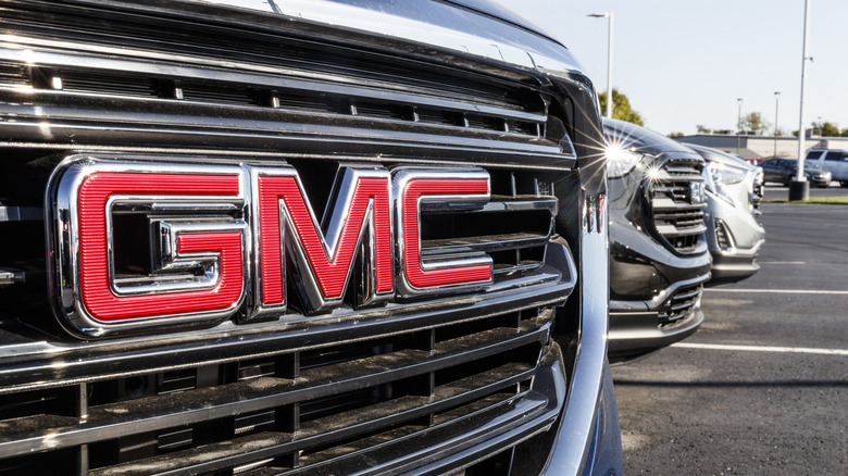 A closeup of a GMC logo on a truck grille