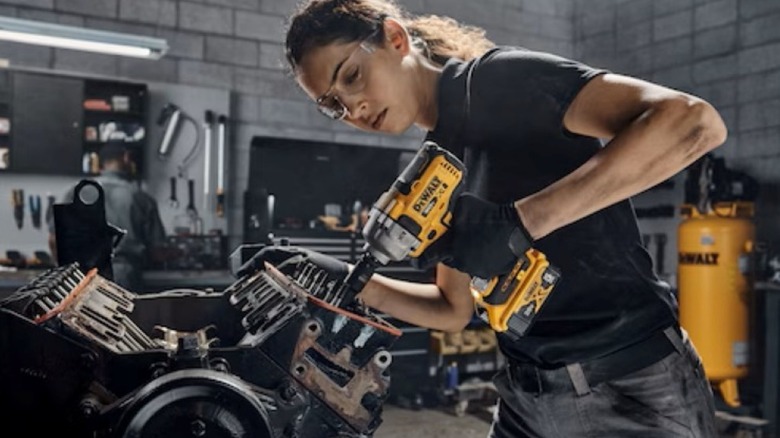 Using a DeWalt DCF891 impact wrench while rebuilding an engine.