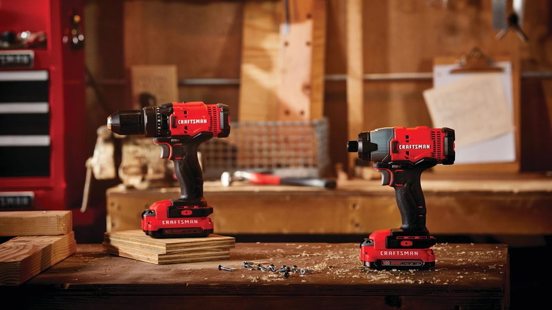 Craftsman half-inch drill and Craftsman impact driver on a table in a workshop
