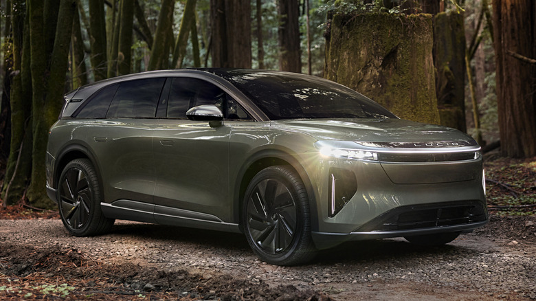 Front 3/4 view of gray Lucid Gravity in forest