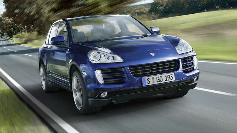 2009 Porsche Cayenne Diesel in blue driving on the road, front 3/4 view