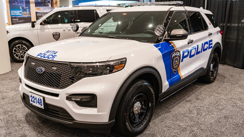 A white Ford Police Interceptor Utility on display.