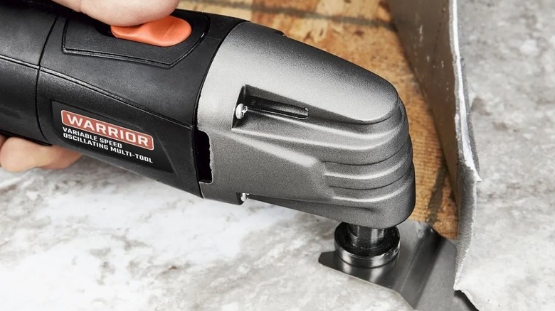 Person using Warrior oscillating tools from Harbor Freight