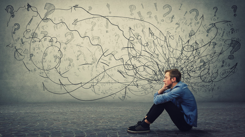 Art of a person contemplating many personalities