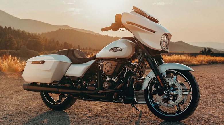 A white 2025 Harley-Davidson Street Glide with arid vegetation in the background at sunset
