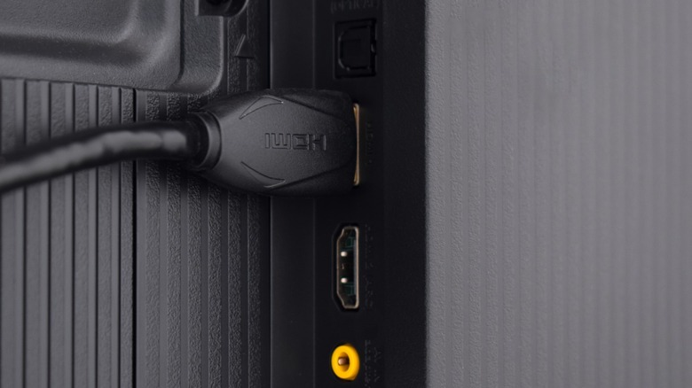 HDMI cable connected to an HDMI port at the back of a TV