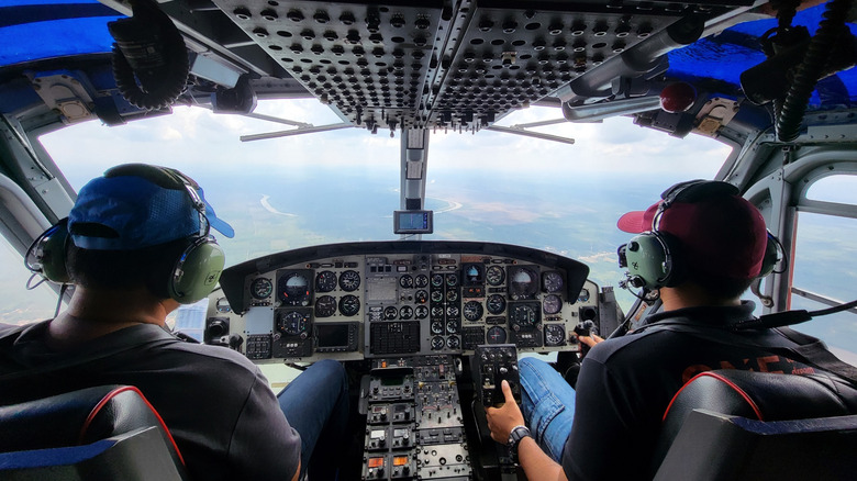A Bell helicopter cockpit with two pilots