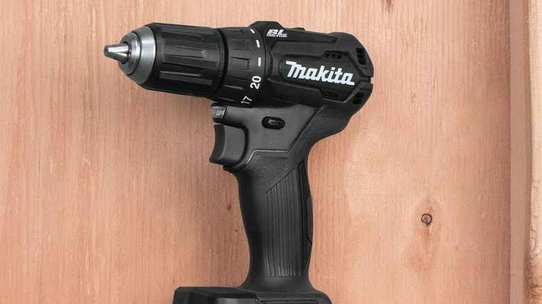 makita drill sitting on wooden ledge