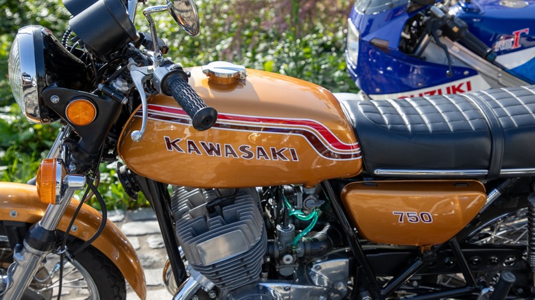 Close up shot of the left side of an orange 750 Kawasaki H2 Mach IV