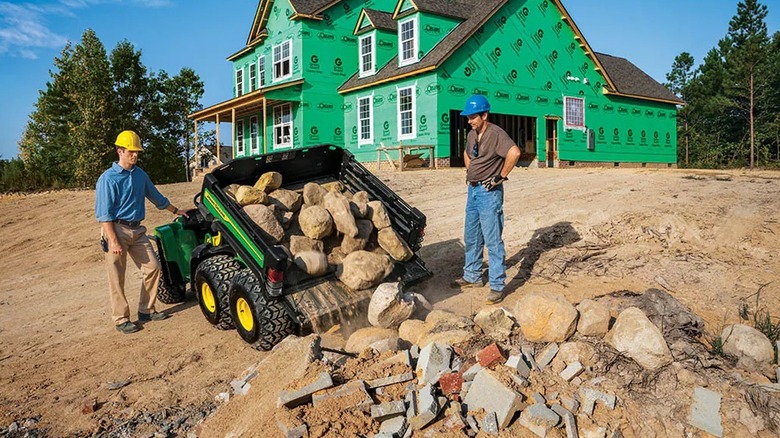 John Deere Gator TH 6x4 Dumping Rocks