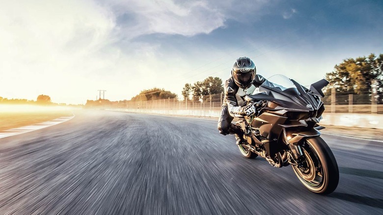 A motorcycle rider driving Kawasaki H2R at high speed