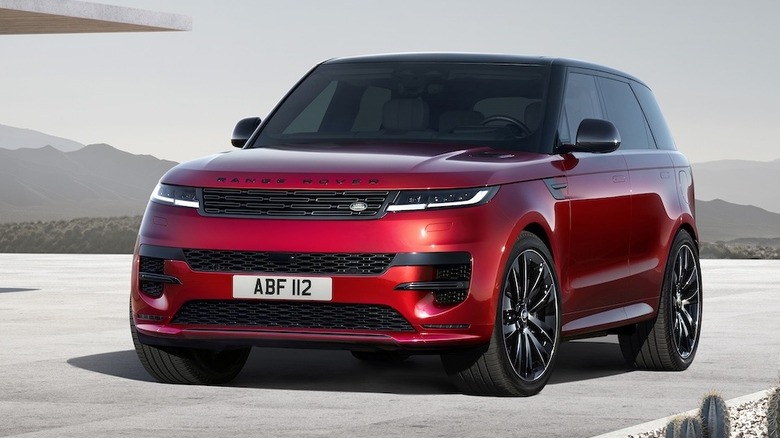 Red 2025 Range Rover Sport parked on concrete with mountains in the background
