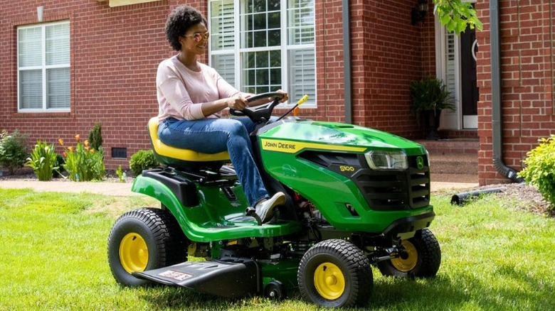Woman driving lawn tractor