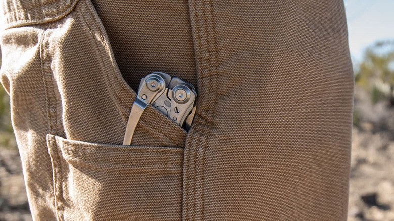 A Leatherman Skeletool 7-in-1 leaning out of trouser pocket.