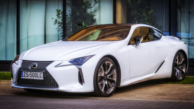 White Lexus LC500 parked alongside a building