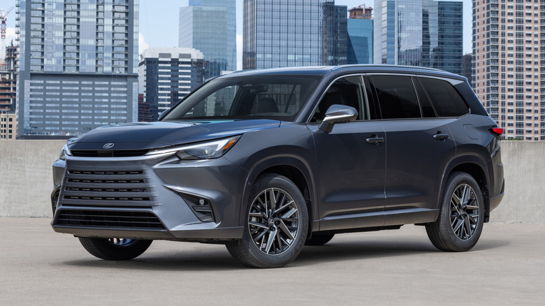 Lexus TX viewed from front angle with cityscape in background