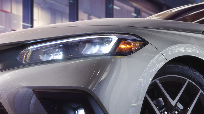 Close-up of front-left headlight on a white 2022 Honda Civic.