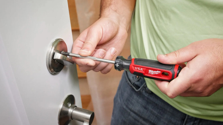 Using screwdriver to adjust lock