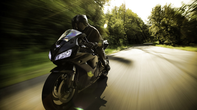 A motorcycle speeding down a road