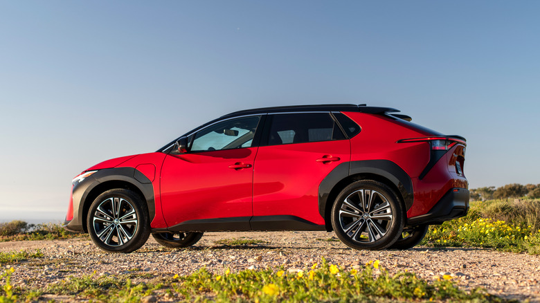 A red 2025 Toyota bZ4X on a hilltop