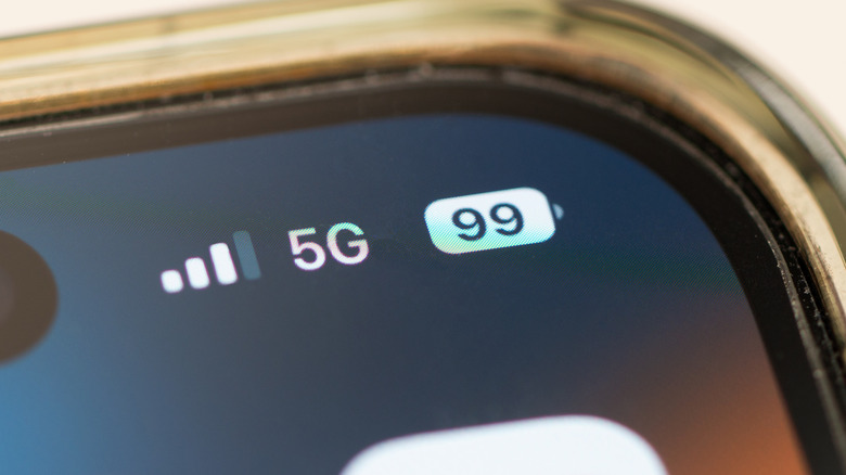 Close-up of an iPhone screen showing a 5G network connection and a full battery