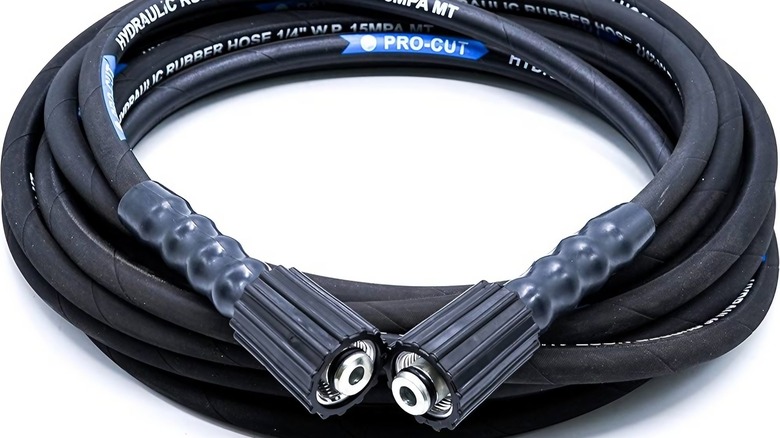 A coil of rubber JPT Pressure Washer Hose Pipe on a white background