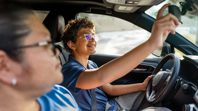 A young teenager learning to drive