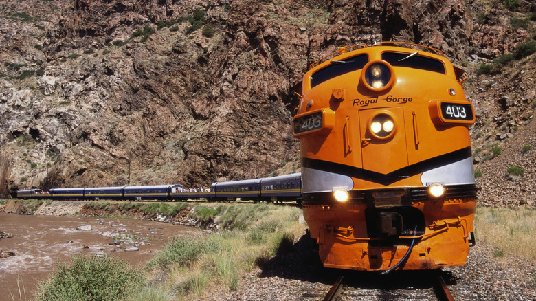 Royal Gorge F-unit locomotive pulling a passenger train through mountainous terrain