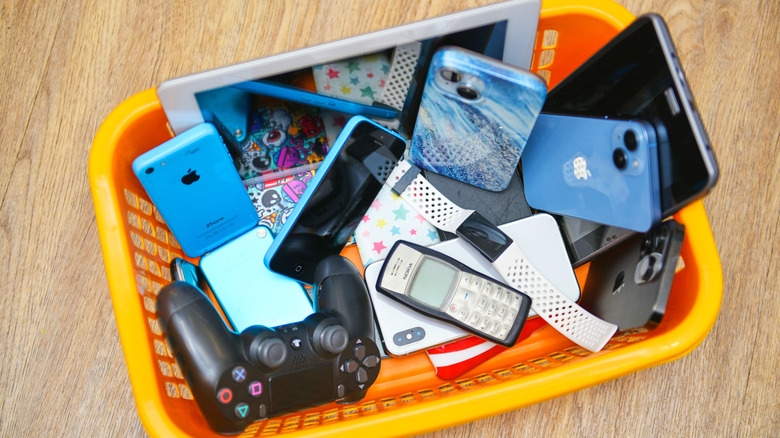Orange basket with old electronics