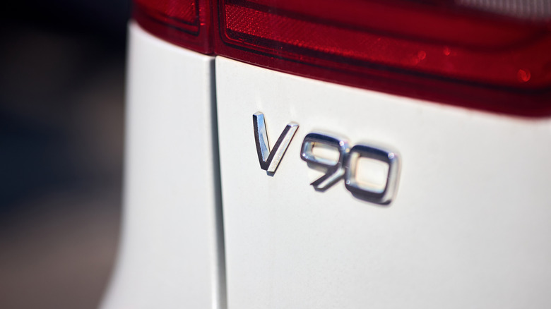 Close-up of Volvo V90 emblem on the rear of a white model
