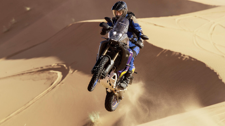A rider jumping over a dune on the Yamaha Tenere 700 World Raid.