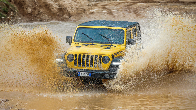 Jeep Wrangler Rubicon driving through muddy waters