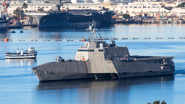 Gray-colored Littoral Combat Ship maneuvering through a busy San Diego bay