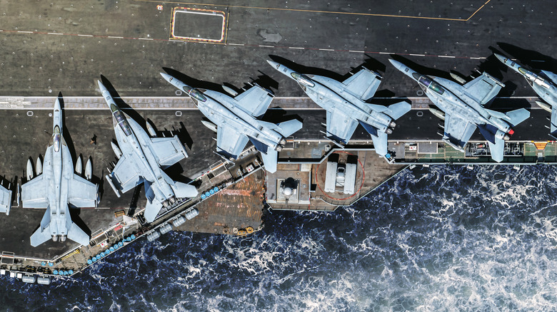 F/A-18E Super Hornet is parked on an American military aircraft carrier at sea