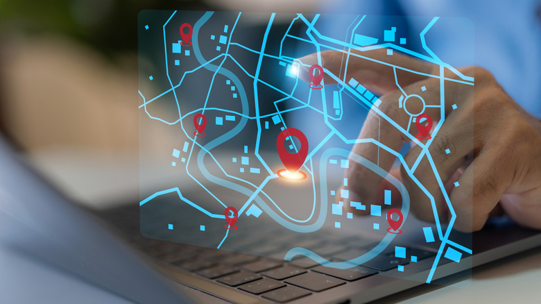 Smart navigation and location tracking with professional hand interacting with futuristic GPS map interface