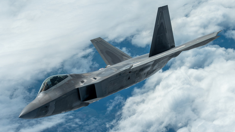 An F-22 Raptor flying above the clouds