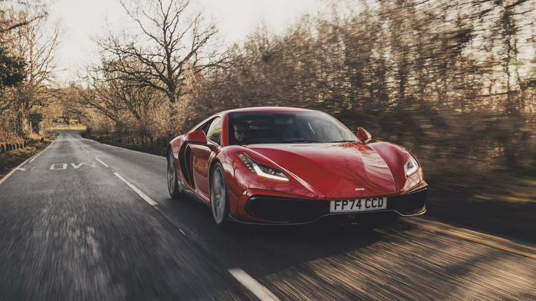 Red Noble M500 driving down a country road