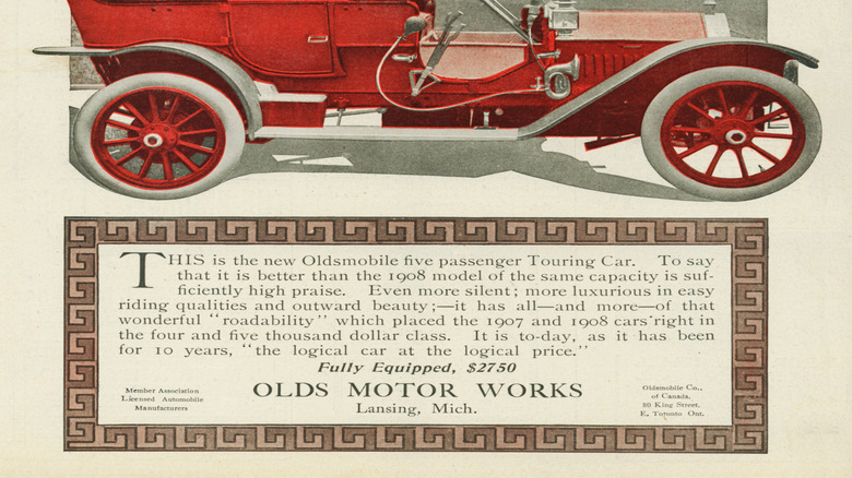 Side view of red 1909 Oldsmobile touring car