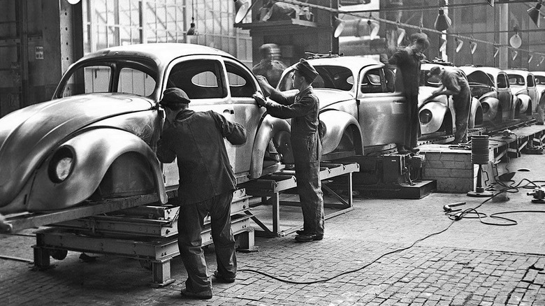 Workers making Beetle bodies on VW assembly line